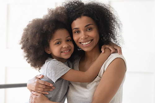 Image Text: 500x332_0038_African single mother and child daughter embrace looking at camera