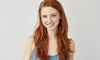 Image Text: 500x332_0039_Happy cheerful ginger girl smiling looking at camera.